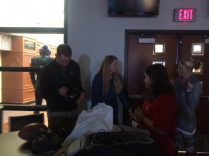 Kliff autographing Terri's Texas Tech goodies after the giving Tuesday shoot. 